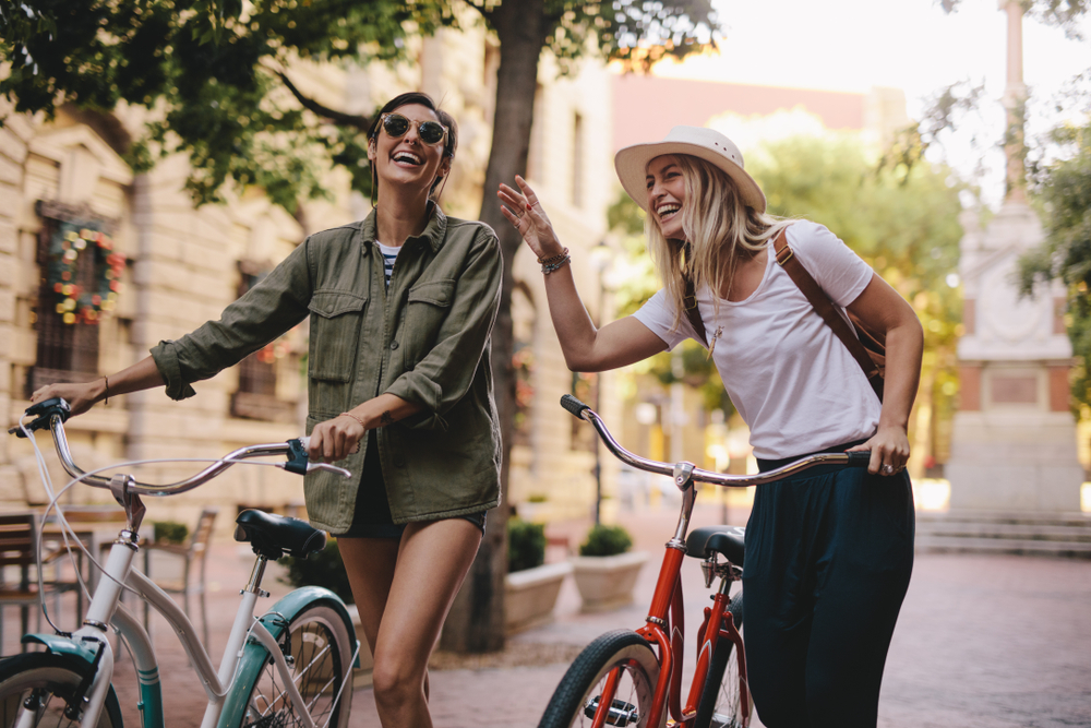 Amiche che visitano la città in bicicletta